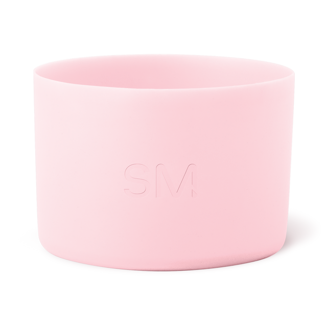 Soft pale pink cylindrical container with smooth sides and open rim, minimalist design Soft pale pink cylindrical container with smooth sides and open rim, minimalist design