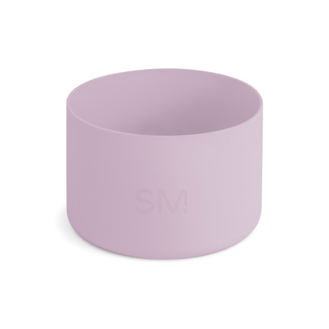 Mauve and lavender pink cylindrical boot or container on off-white background Mauve and lavender pink cylindrical boot or container on off-white background
