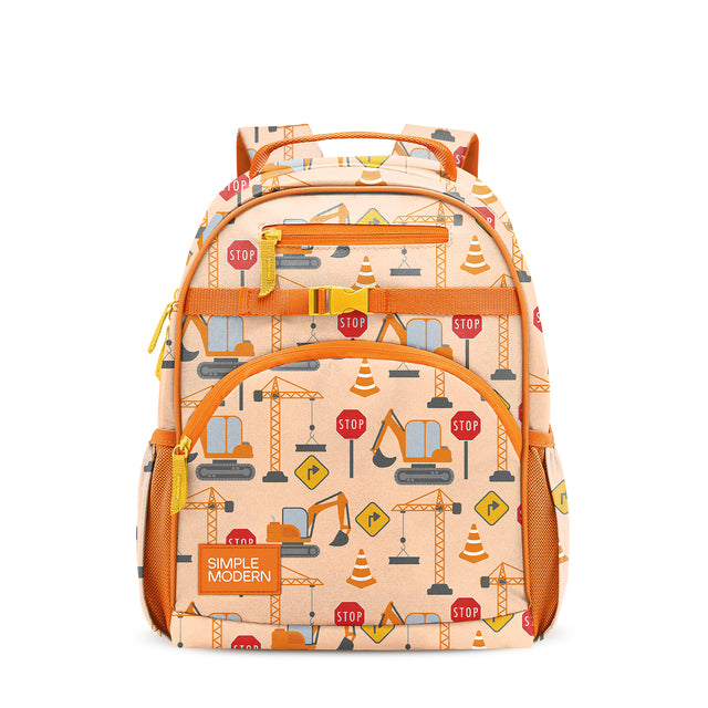 Peachy-beige children's backpack with bright orange accents, padded straps, multiple zippered compartments, mesh pockets, and construction-themed print in yellow, red, and blue. Simple Modern logo on front. Peachy-beige children's backpack with bright orange accents, padded straps, multiple zippered compartments, mesh pockets, and construction-themed print in yellow, red, and blue. Simple Modern logo on front.