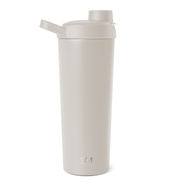 Cylindrical cream-colored vessel with soft neutral beige tones and minimalist design against a plain background. Cylindrical cream-colored vessel with soft neutral beige tones and minimalist design against a plain background.