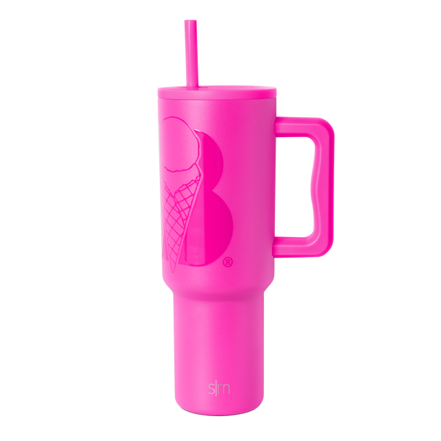 Hot pink insulated tumbler with handle and reusable straw on white background. Tapered design widens at top, narrows at base. Hot pink insulated tumbler with handle and reusable straw on white background. Tapered design widens at top, narrows at base.
