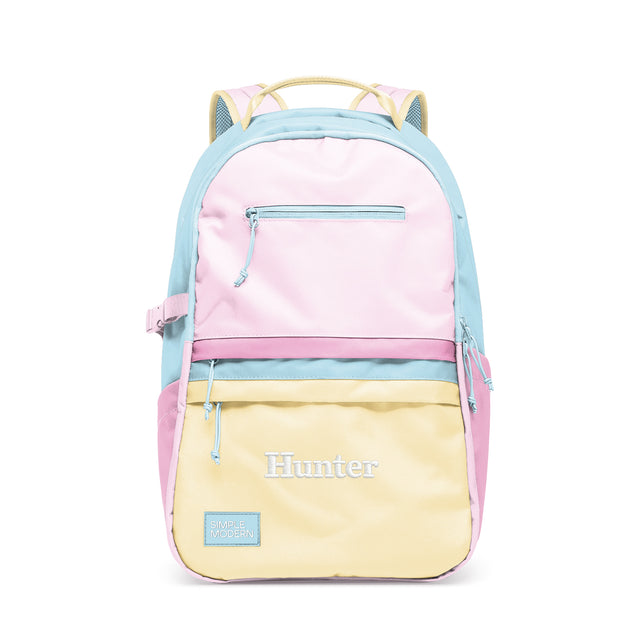 Pastel color-block backpack with horizontal bands of pink, blue, and yellow, featuring multiple zippered pockets, Pastel color-block backpack with horizontal bands of pink, blue, and yellow, featuring multiple zippered pockets,