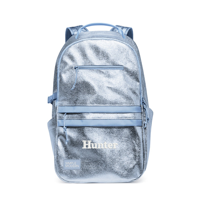 Light blue metallic backpack with dual padded straps, top handle, and front zippered pocket. Features Light blue metallic backpack with dual padded straps, top handle, and front zippered pocket. Features