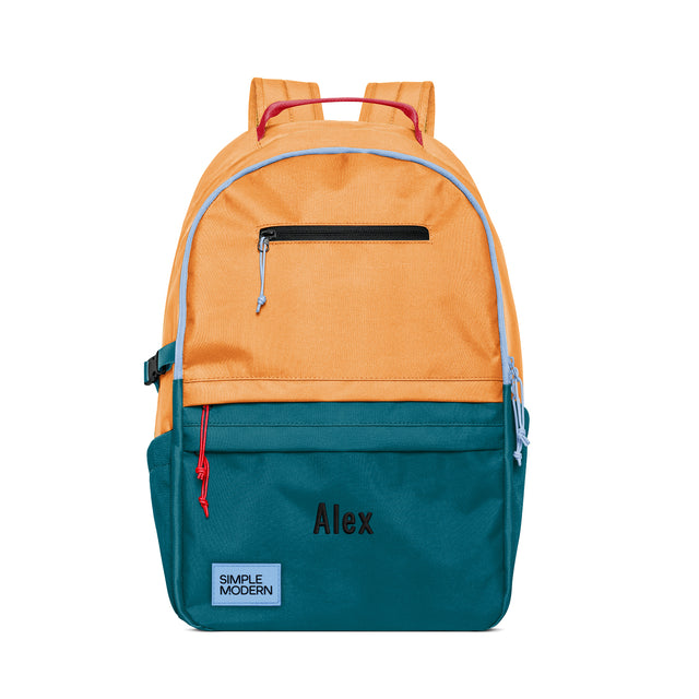 Colorblock backpack with peachy-orange top, periwinkle trim, and teal bottom, featuring magenta-pink padded straps, black zippered pocket, and Colorblock backpack with peachy-orange top, periwinkle trim, and teal bottom, featuring magenta-pink padded straps, black zippered pocket, and