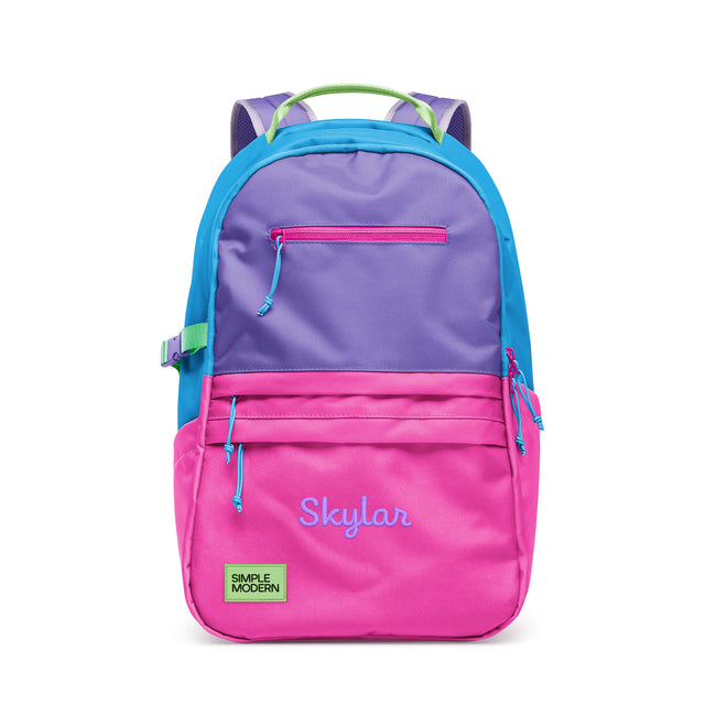 Colorful children's backpack with bright pink lower section, purple upper compartment, blue side panels, and lime green handles, featuring multiple zippered pockets and Colorful children's backpack with bright pink lower section, purple upper compartment, blue side panels, and lime green handles, featuring multiple zippered pockets and