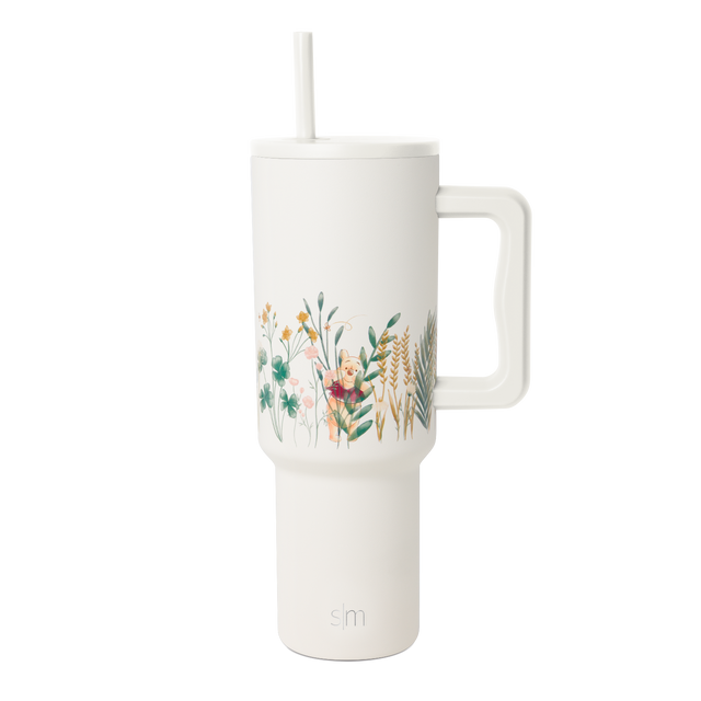 Cream-colored tumbler with botanical leaf design wrapping around the upper portion, modern minimalist style. Cream-colored tumbler with botanical leaf design wrapping around the upper portion, modern minimalist style.