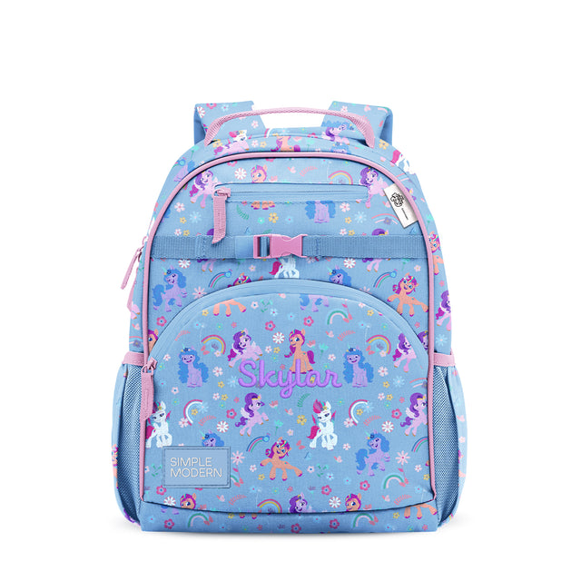 Skylar children's backpack by Simple Modern in light periwinkle blue with hot pink straps, featuring colorful unicorn and rainbow pattern, multiple zippered pockets, and mesh side compartments. Skylar children's backpack by Simple Modern in light periwinkle blue with hot pink straps, featuring colorful unicorn and rainbow pattern, multiple zippered pockets, and mesh side compartments.