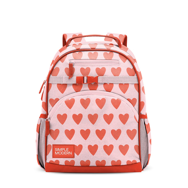 Light pink children's backpack with coral-red heart pattern, padded handles, cushioned straps, front zippered pocket, side mesh pockets, and coral-red bottom panel. Simple Modern branded label visible. Light pink children's backpack with coral-red heart pattern, padded handles, cushioned straps, front zippered pocket, side mesh pockets, and coral-red bottom panel. Simple Modern branded label visible.