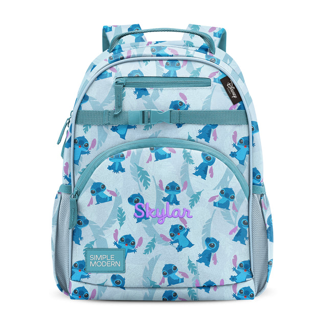 Children's backpack in pale blue with teal, navy, purple-pink, and mint green pattern. Features front pocket with Children's backpack in pale blue with teal, navy, purple-pink, and mint green pattern. Features front pocket with