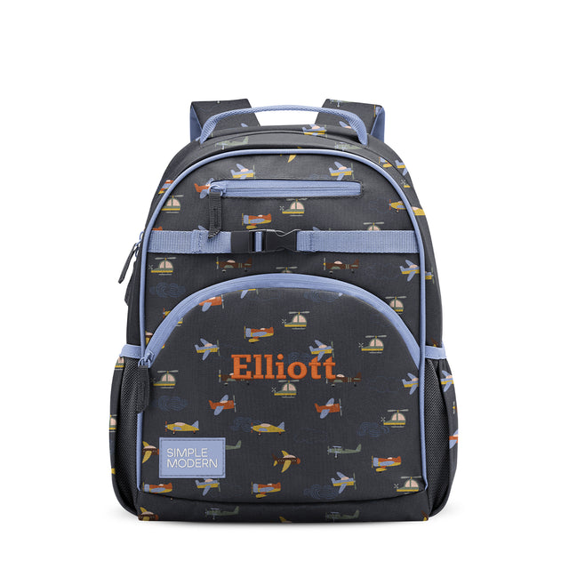 Children's backpack with charcoal gray base, periwinkle blue straps and pockets, featuring transportation-themed print with airplanes and sailboats. Children's backpack with charcoal gray base, periwinkle blue straps and pockets, featuring transportation-themed print with airplanes and sailboats.