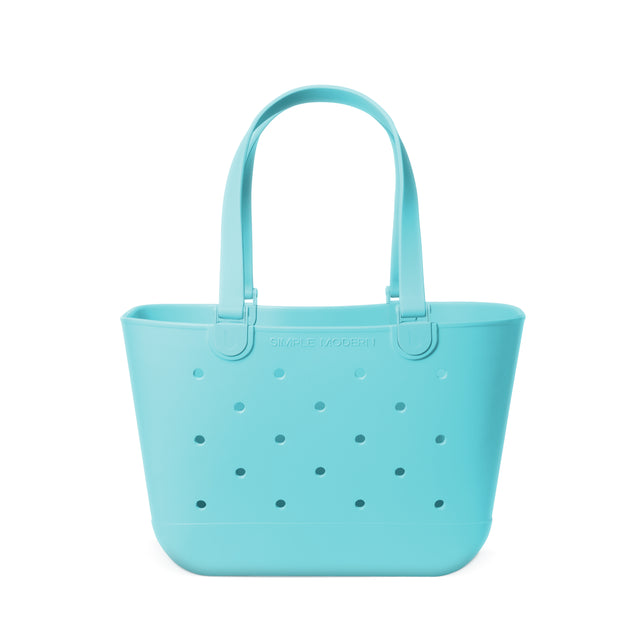 Mint blue perforated tote bag with arched handles and Simple Modern branding, shown against a white background. Mint blue perforated tote bag with arched handles and Simple Modern branding, shown against a white background.