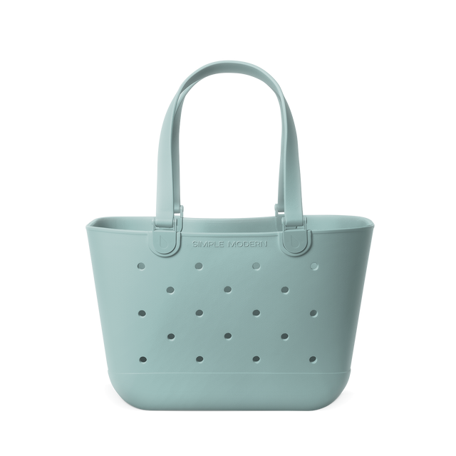 Soft sage green tote bag displayed against a neutral background. The bag features sturdy handles and a spacious rectangular silhouette, shown in a muted celadon blue-green tone throughout. Soft sage green tote bag displayed against a neutral background. The bag features sturdy handles and a spacious rectangular silhouette, shown in a muted celadon blue-green tone throughout.