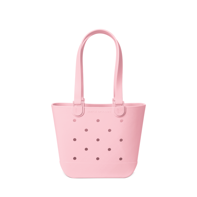 Soft pink tote bag against a white background Soft pink tote bag against a white background