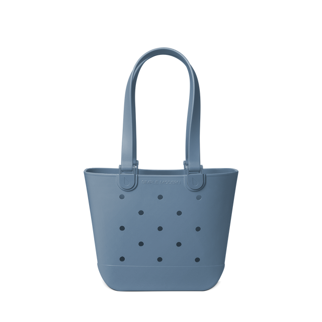 Soft blue-grey muted tote bag on light neutral background Soft blue-grey muted tote bag on light neutral background