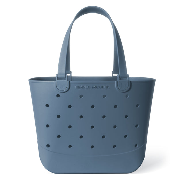Soft blue-gray tote bag with dark charcoal perforations, neutral color in muted slate tone. Soft blue-gray tote bag with dark charcoal perforations, neutral color in muted slate tone.