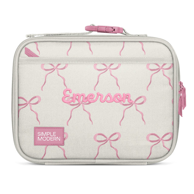 Soft gray-beige insulated lunch bag with pink embroidered bows, pink handle, and personalization reading Soft gray-beige insulated lunch bag with pink embroidered bows, pink handle, and personalization reading