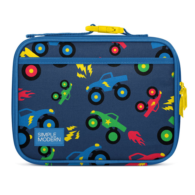 Navy blue kids lunch box by Simple Modern with colorful toy truck and rocket pattern, yellow carry handle and zipper pull, padded soft-sided design for insulated food storage. Navy blue kids lunch box by Simple Modern with colorful toy truck and rocket pattern, yellow carry handle and zipper pull, padded soft-sided design for insulated food storage.