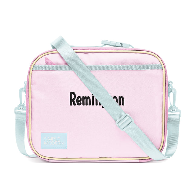 Pale pink rectangular lunch bag with sage green shoulder strap and handles, cream piping trim, and Pale pink rectangular lunch bag with sage green shoulder strap and handles, cream piping trim, and