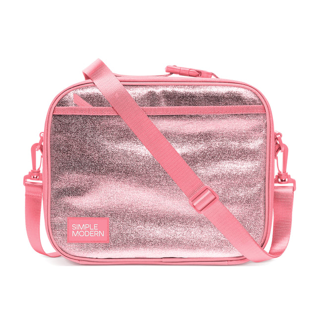 Simple Modern insulated lunch bag in bubblegum pink with metallic silver glittery striped exterior, dual top handles, and adjustable shoulder strap, displayed against white background. Simple Modern insulated lunch bag in bubblegum pink with metallic silver glittery striped exterior, dual top handles, and adjustable shoulder strap, displayed against white background.