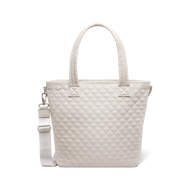 Cream-colored canvas tote bag displayed against white background, front view showing simple, minimalist design with neutral beige tone and clean aesthetic. Cream-colored canvas tote bag displayed against white background, front view showing simple, minimalist design with neutral beige tone and clean aesthetic.
