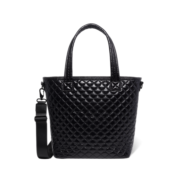 Black quilted handbag with light reflections on white background Black quilted handbag with light reflections on white background
