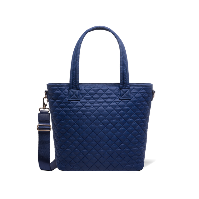 Navy blue tote bag with carabiner clip and metal hardware accents on shoulder strap Navy blue tote bag with carabiner clip and metal hardware accents on shoulder strap