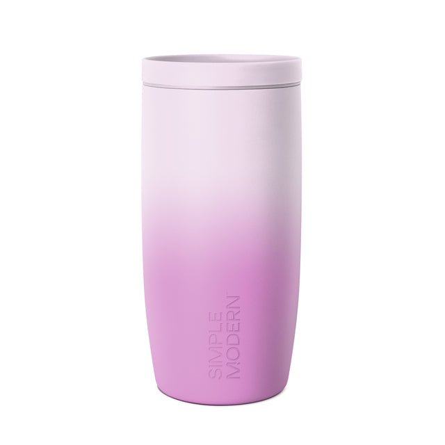 Lavender to magenta ombre tumbler with lid against white background. Simple Modern branding visible on lower body. Matte finish cylindrical drinkware with rounded base and fitted lid. Lavender to magenta ombre tumbler with lid against white background. Simple Modern branding visible on lower body. Matte finish cylindrical drinkware with rounded base and fitted lid.