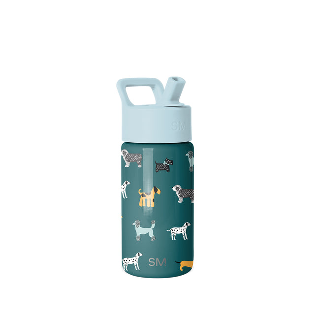 Deep teal Simple Modern kids water bottle with light blue lid and carrying handle, featuring repeating dog illustrations in white, cream, black, and yellow. SM logo visible on lid and body. Deep teal Simple Modern kids water bottle with light blue lid and carrying handle, featuring repeating dog illustrations in white, cream, black, and yellow. SM logo visible on lid and body.