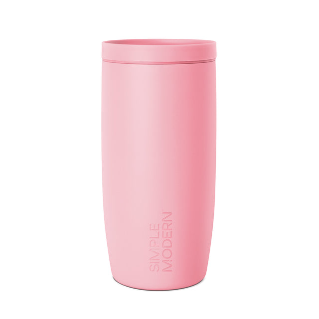 Rose pink cylindrical tumbler with matching lid by Simple Modern, displayed against white background with soft shadow detail. Rose pink cylindrical tumbler with matching lid by Simple Modern, displayed against white background with soft shadow detail.
