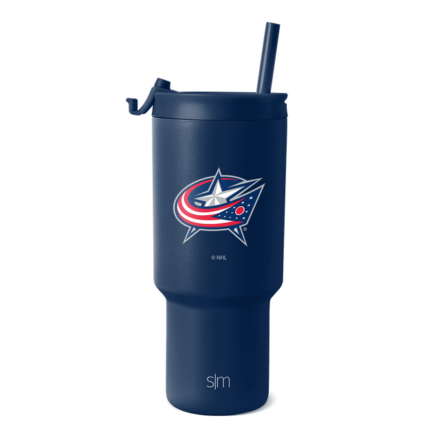 Navy blue insulated tumbler with fitted lid and matching straw on white background. Cylindrical shape with wider base tapering toward top. Navy blue insulated tumbler with fitted lid and matching straw on white background. Cylindrical shape with wider base tapering toward top.