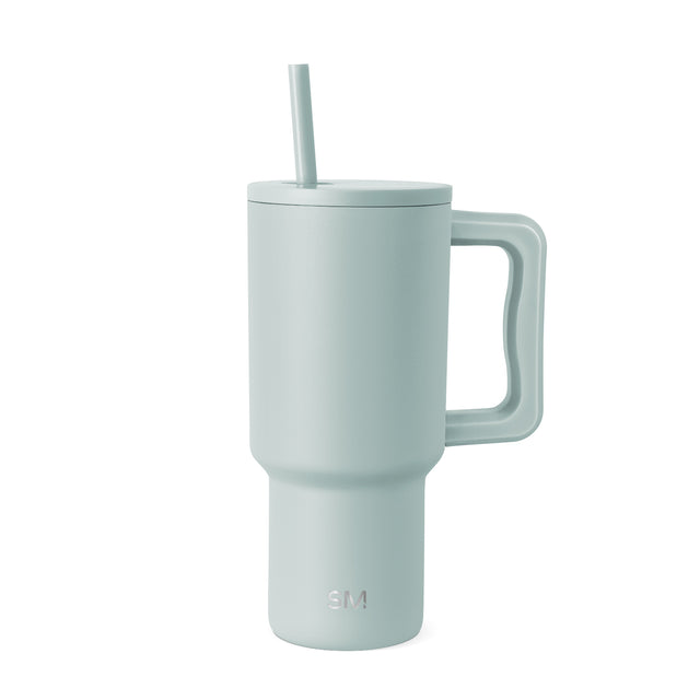 Sage green insulated travel tumbler with handle and matching lid featuring integrated straw, displayed against white background. Simple Modern branded product. Sage green insulated travel tumbler with handle and matching lid featuring integrated straw, displayed against white background. Simple Modern branded product.
