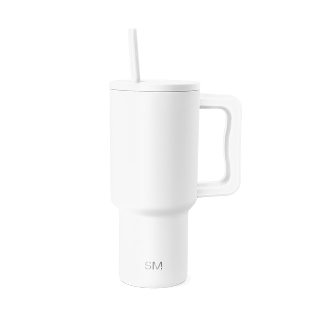White insulated tumbler with lid and handle, shown against neutral background White insulated tumbler with lid and handle, shown against neutral background