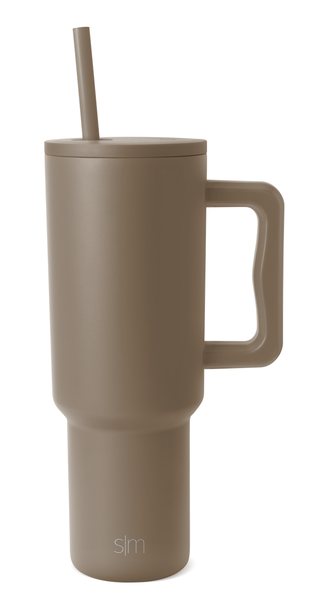 Taupe ceramic travel mug with white background, featuring a cylindrical shape with a secure lid and handle, designed for hot beverages Taupe ceramic travel mug with white background, featuring a cylindrical shape with a secure lid and handle, designed for hot beverages