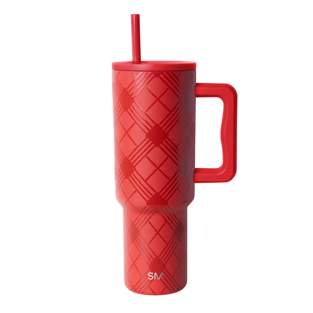 Coral-red insulated tumbler with matching handle, lid, and straw on neutral background Coral-red insulated tumbler with matching handle, lid, and straw on neutral background