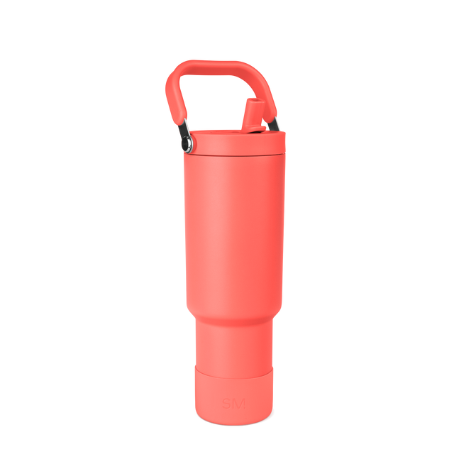 Coral-red insulated water bottle with black handle and carabiner clip on white background Coral-red insulated water bottle with black handle and carabiner clip on white background