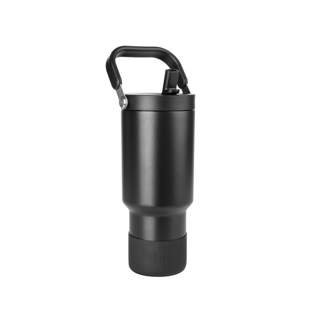 Matte black cylindrical drinkware with metallic gray accents and dark handle against black background Matte black cylindrical drinkware with metallic gray accents and dark handle against black background