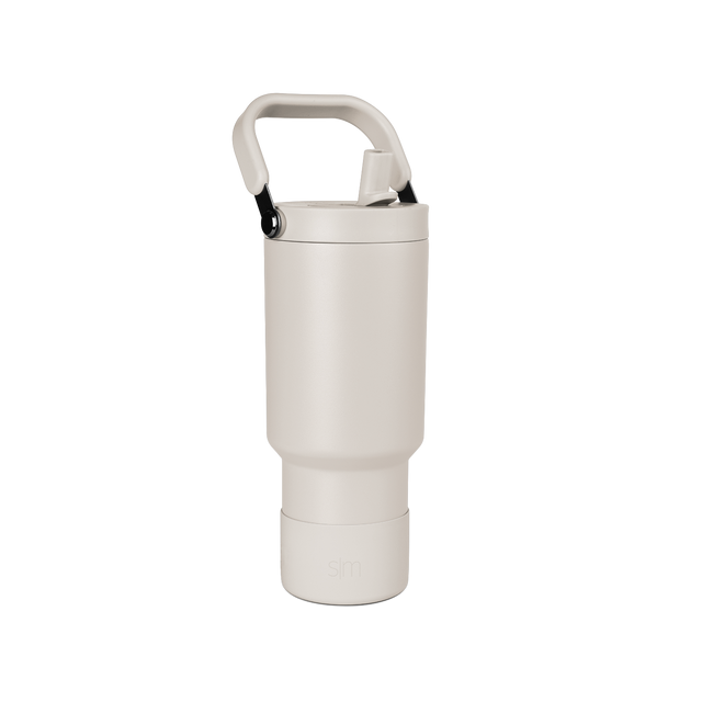 Pale beige cylindrical vessel with cream-colored closure cap on neutral off-white background. Pale beige cylindrical vessel with cream-colored closure cap on neutral off-white background.