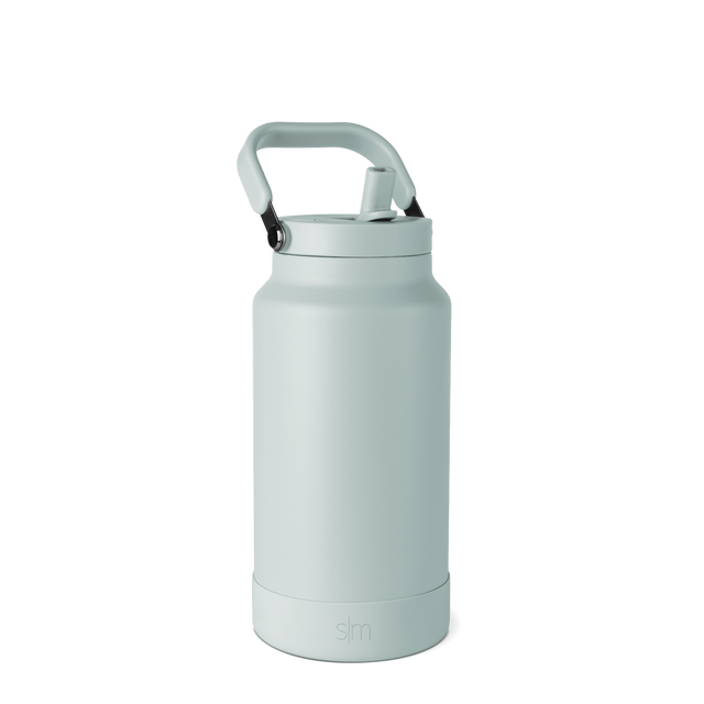 Pale seafoam green insulated water bottle with matching carry handle and base, monochromatic design Pale seafoam green insulated water bottle with matching carry handle and base, monochromatic design
