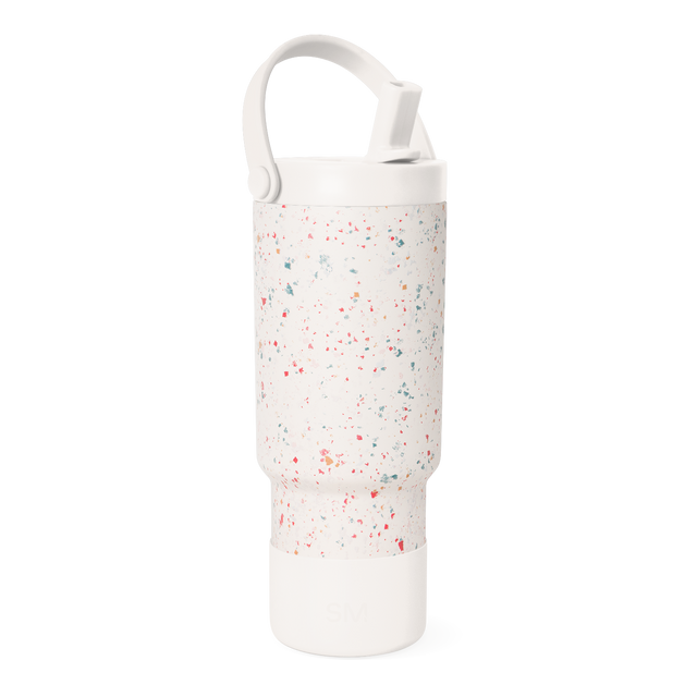Cream-colored water bottle with multicolored speckled pattern including coral red, pink, teal, sage green, and muted orange accents. Cream-colored water bottle with multicolored speckled pattern including coral red, pink, teal, sage green, and muted orange accents.