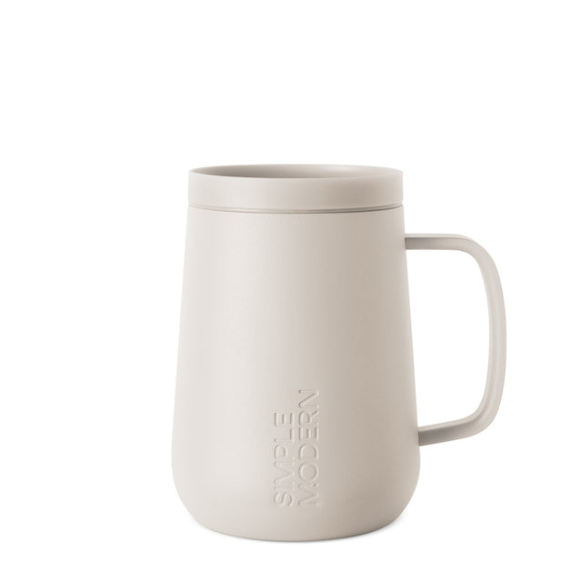 Cream-colored ceramic mug with handle on white background Cream-colored ceramic mug with handle on white background