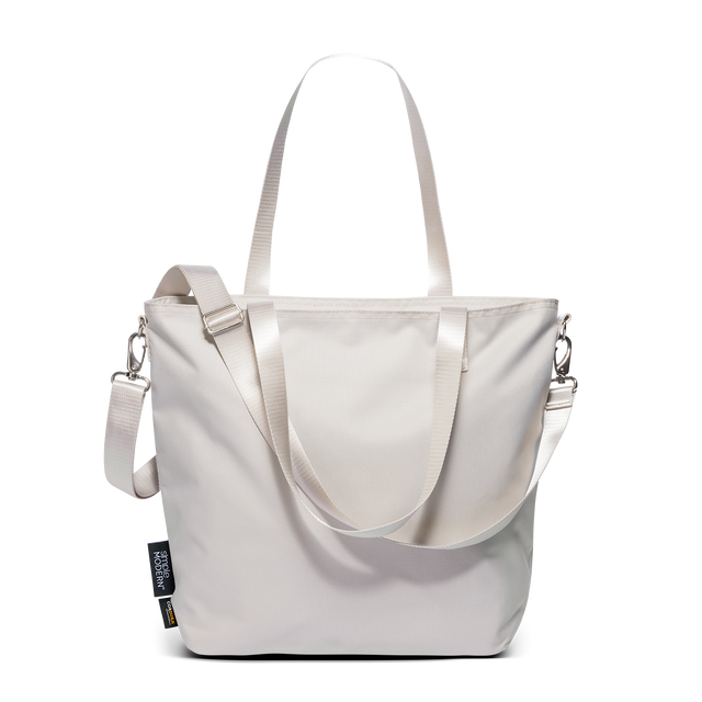 Harper Tote in cream Cordura fabric with dual webbing handles, adjustable crossbody strap, and silver-tone hardware on white background. Harper Tote in cream Cordura fabric with dual webbing handles, adjustable crossbody strap, and silver-tone hardware on white background.