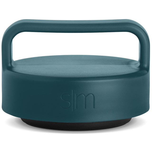 Muted teal jar lid with dark charcoal base against clean white background Muted teal jar lid with dark charcoal base against clean white background