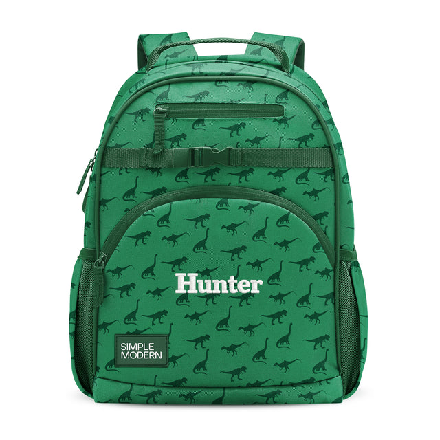 Green children's backpack with dinosaur pattern, padded shoulder straps, front zippered pockets, side mesh pockets, and 
