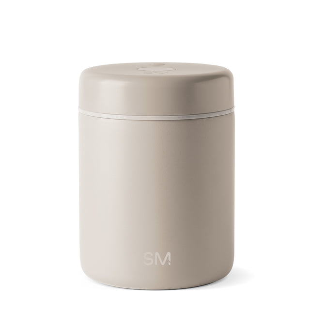 Beige cream-colored container with light gray horizontal accent line at mid-section where lid meets base, minimalist design with soft neutral tones