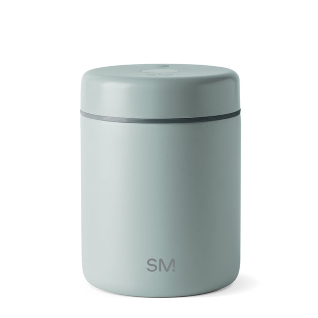 Sage green cylindrical canister with charcoal gray horizontal accent band, modern minimalist design