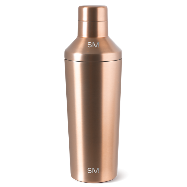 Cylindrical vessel with warm rose gold metallic finish and polished, reflective surface