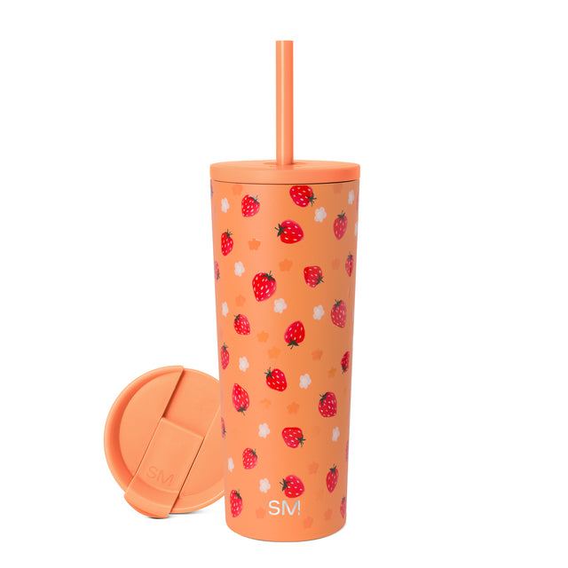 Peachy-orange tumbler with red strawberries featuring yellow seeds and dark green leaves, white accents throughout