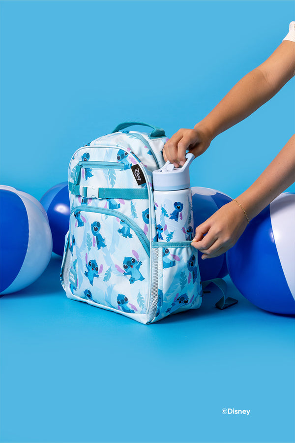 Child's blue and teal backpack with Stitch character design, featuring insulated water bottle, displayed against blue background with child's hand reaching in.