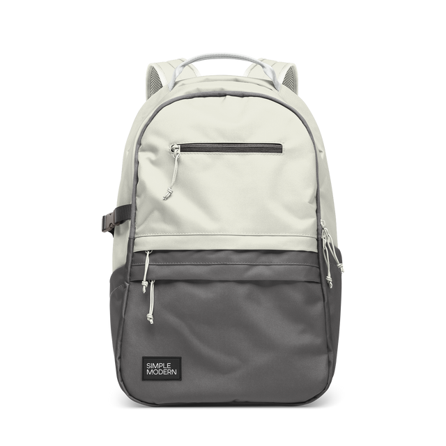 Cream and charcoal gray two-tone backpack with gray accent straps and piping trim along the edges where the colors meet.