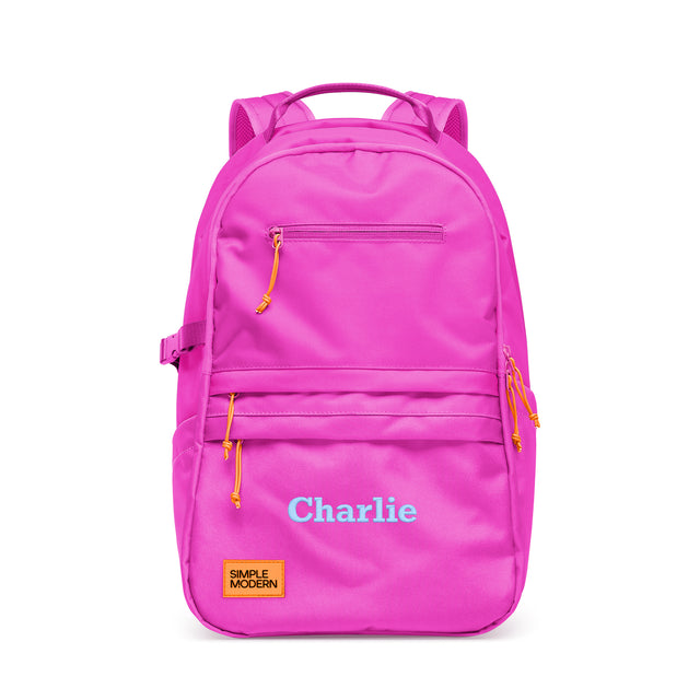 Hot pink backpack with yellow and orange zipper pulls, personalized with 